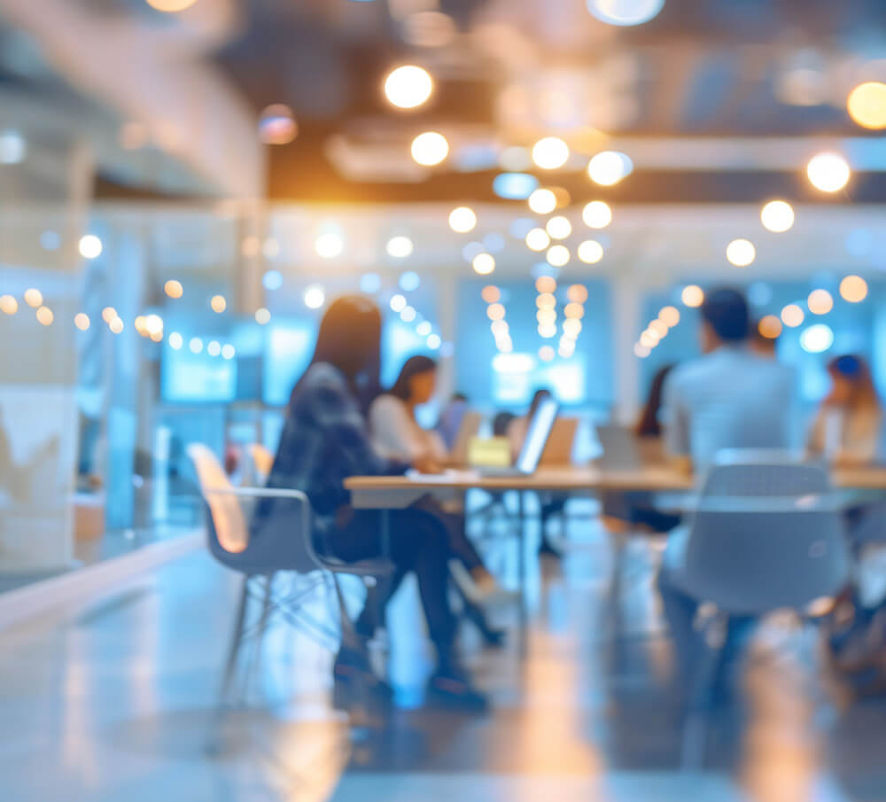 Professionals sitting at a community table in an office