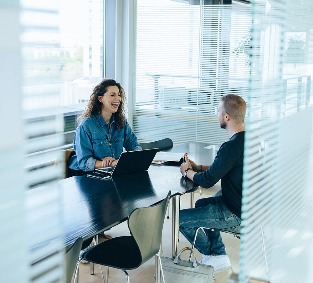 Professionals sitting at a table in an office conducting a meeting Professionals sitting at a table in an office conducting a meeting