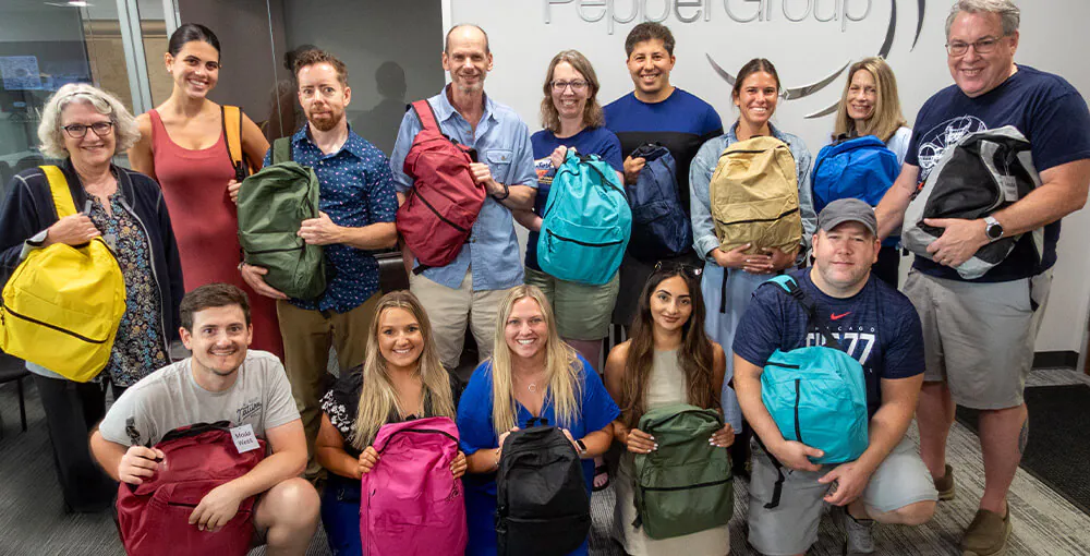 The Pepper Group team packed backpacks for kids